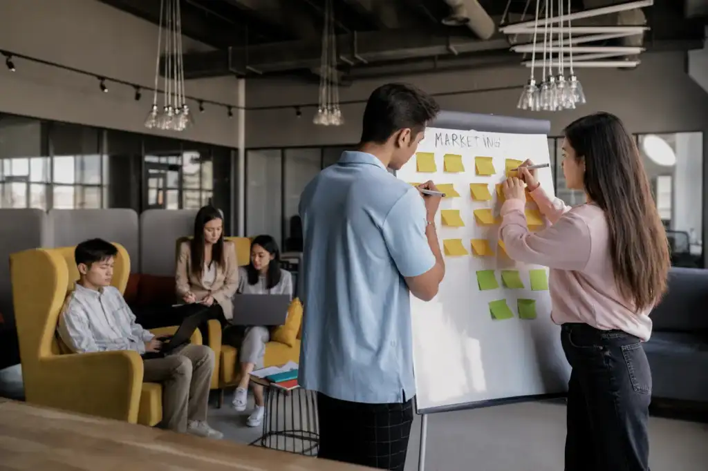Marketing team collaborating at a whiteboard in a digital agency