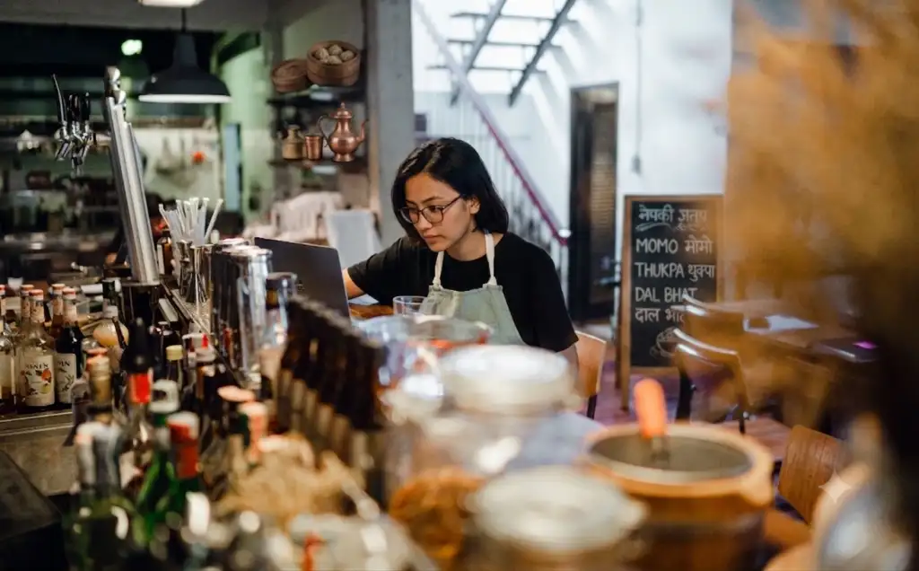 Nepali restaurant owner using laptop for online visibility